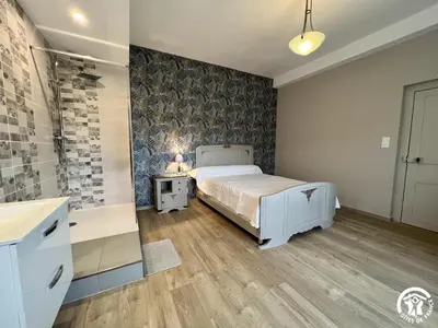a bedroom with a bed and a sink and a tub at Peyret in Cépie