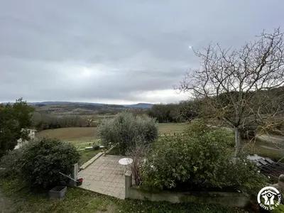 a brick walkway in a field with bushes and trees at Peyret in Cépie