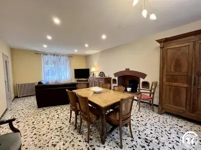 a living room with a dining room table and a couch at Peyret in Cépie