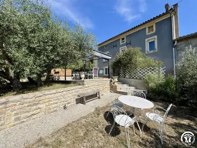 a table and chairs in front of a building at Peyret in Cépie