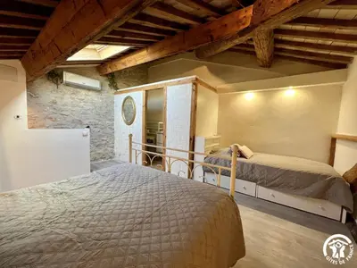 a bedroom with two beds in a room at La ruche in Durban-Corbières