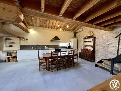 a kitchen with a table and chairs in a room at La ruche in Durban-Corbières