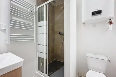 a bathroom with a shower and a toilet and a sink at T3 apartment in the heart of Cuxac-d'Aude in Cuxac-dʼAude
