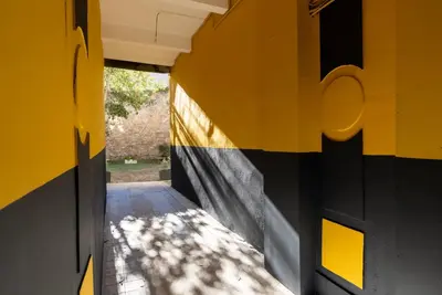 a hallway with a yellow and black wall at La PARERIE 2 in Carcassonne
