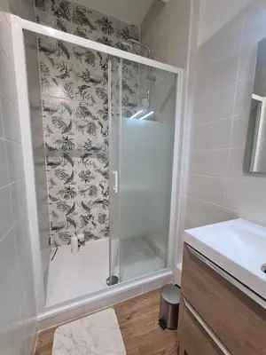 a bathroom with a shower with a glass door at Douces Vagues - hypercentre climatisé in Narbonne