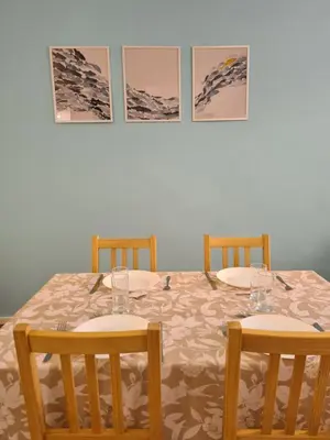 a table with two chairs and two wine glasses on it at Douces Vagues - hypercentre climatisé in Narbonne