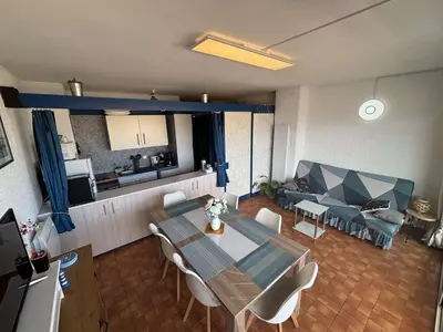 a living room with a dining table and a couch at Appart 2 pièces Cabine PORT LA NOUVELLE PN590-022 in Port-la-Nouvelle