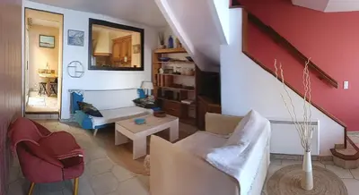 a living room with a couch and a table at La Voile Méditerranéenne in Port-la-Nouvelle