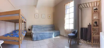 a bedroom with a bed and a bunk bed at La Voile Méditerranéenne in Port-la-Nouvelle