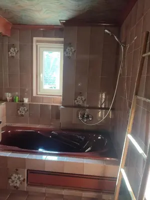 a bath tub in a bathroom with a window at Chambre d'hôtes Zen à Mazamet, avec garage vélos motos in Mazamet