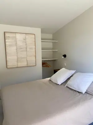 a bedroom with a bed with two pillows and a window at Chambre d'Hôtes Dahlia - Boutenac in Boutenac