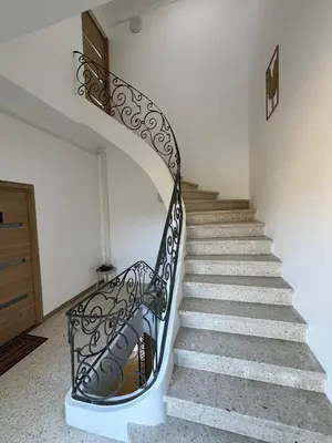 a staircase in a house with a wrought iron railing at Élégant studio avec jacuzzi in Saint-Paul-de-Fenouillet