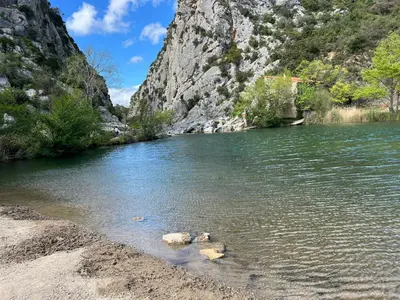 a river with rocks in the water next to a mountain at Élégant studio avec jacuzzi in Saint-Paul-de-Fenouillet