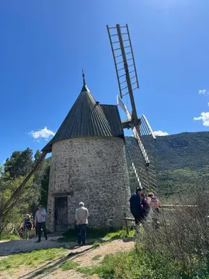 a group of people standing around a windmill at Élégant studio avec jacuzzi in Saint-Paul-de-Fenouillet