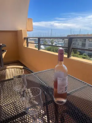 a bottle of wine sitting on a table with glasses at Évasion Méditerranéenne in Gruissan