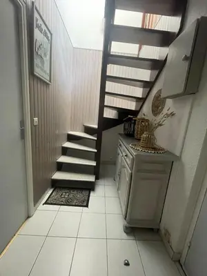a staircase in a room with a tiled floor at Évasion Méditerranéenne in Gruissan
