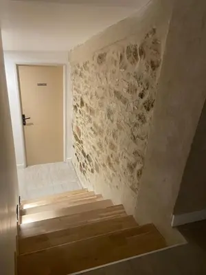 a shower with a glass door in a bathroom at Gite charme et confort in Sainte-Vallière