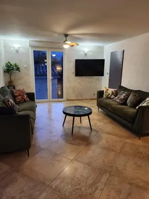 a living room with two couches and a coffee table at Villa Monze in Carcassonne