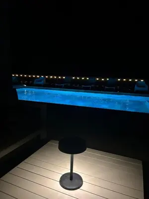 a stool sitting in front of a bar with lights at Villa Monze in Carcassonne
