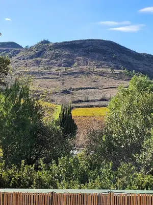 a field with a hill in the background with a fence at Villa Monze in Carcassonne