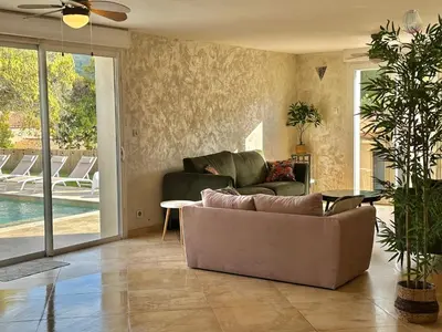a living room with a couch and a pool at Villa Monze in Carcassonne