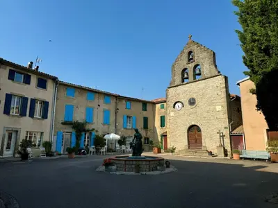 a building with a clock tower and a church at night at Les lits de Montbel B&B in Sonnac-sur-lʼHers