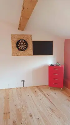 a childs room with an orange wall and a basketball hoop at Les lits de Montbel B&B in Sonnac-sur-lʼHers