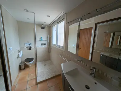 a bathroom with a sink and a toilet and a mirror at La Plénitude in Narbonne
