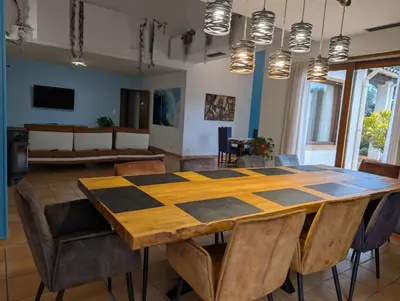 a dining room with a checkered table and chairs at La Plénitude in Narbonne