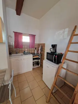 a small kitchen with a stove and a microwave at Studio Cosy, proche du port, tout se fait à pied in Port-la-Nouvelle