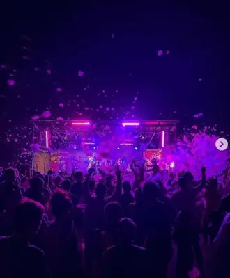 a crowd of people at a concert with purple lights at Studio Cosy, proche du port, tout se fait à pied in Port-la-Nouvelle