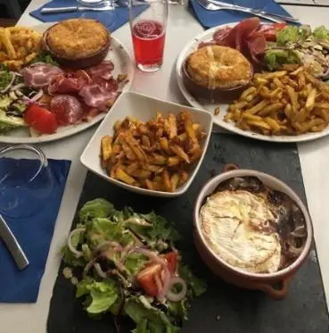 a table with many plates of food on it at Studio Cosy, proche du port, tout se fait à pied in Port-la-Nouvelle