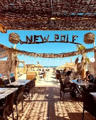 a restaurant patio with tables and chairs and a new bite sign at Studio Cosy, proche du port, tout se fait à pied in Port-la-Nouvelle