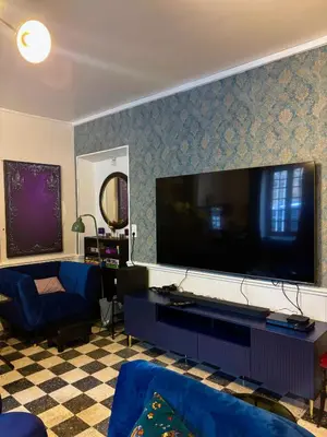 a living room with a large flat screen tv at Babouz Cottage in Mirepoix