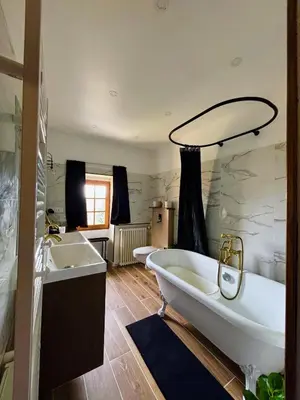 a large bathroom with two sinks and a tub at Babouz Cottage in Mirepoix