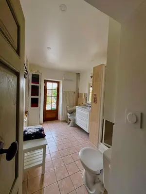 a bathroom with a toilet and a sink at Babouz Cottage in Mirepoix