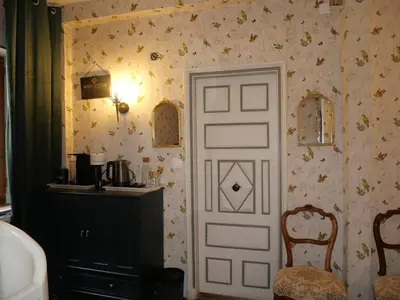 a room with a door and a table and a chair at Babouz Cottage in Mirepoix