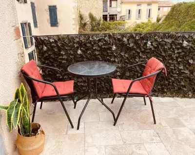 two chairs and a table on a patio at Babouz Cottage in Mirepoix