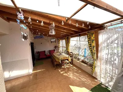 a dining room with a table and chairs in a house at Maison 8 couchages - Port la Nouvelle - PN000-048 in Port-la-Nouvelle