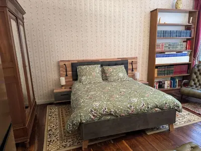 a bedroom with a bed and a book shelf at Appartement Centre Ville in Mirepoix