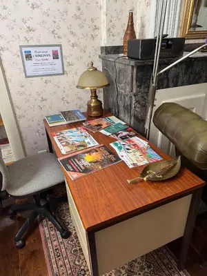 a wooden desk with a lamp and a chair at Appartement Centre Ville in Mirepoix