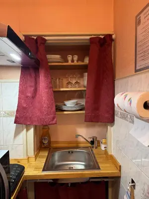 a kitchen sink with two red towels above it at Appartement Centre Ville in Mirepoix