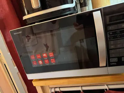 a microwave oven sitting on top of a table at Appartement Centre Ville in Mirepoix