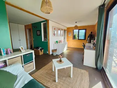 a living room with a couch and a table at Maison contemporaine en bois au coeur des Corbières in Ferrals-lès-Corbières