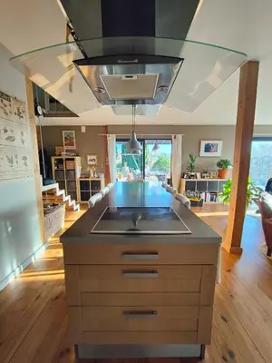 a kitchen island with a sink in a room at Maison contemporaine en bois au coeur des Corbières in Ferrals-lès-Corbières