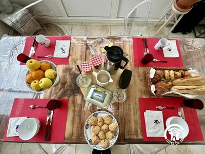 a table with food and bread on top of it at La cazabanelle in Villegly