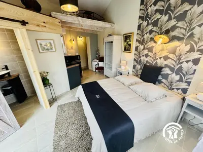 a bedroom with a large bed in a room at La cazabanelle in Villegly