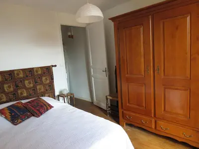 a bedroom with a large wooden cabinet and a bed at BELESTAGITE7 Pays Catalan 66 in Bélesta