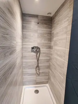 a bathroom with a shower with a tub at L'Atelier des Carmes in Pamiers