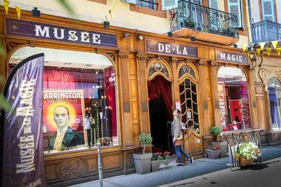 a man standing in front of a store at L'Atelier des Carmes in Pamiers
